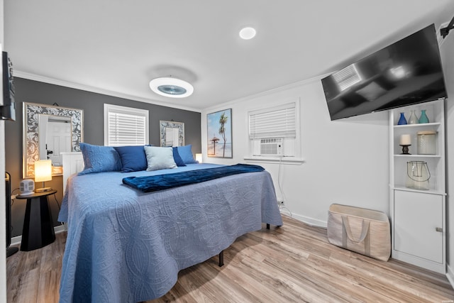 bedroom featuring crown molding, baseboards, and wood finished floors