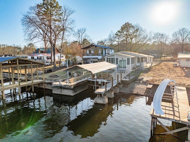 dock area featuring boat lift, a residential view, and a water view