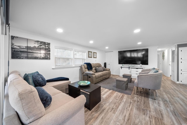 living area featuring crown molding, recessed lighting, and wood finished floors