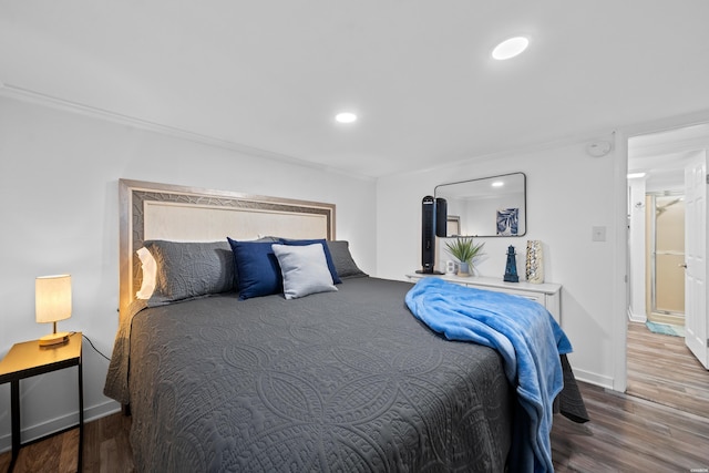 bedroom featuring recessed lighting, crown molding, baseboards, and wood finished floors