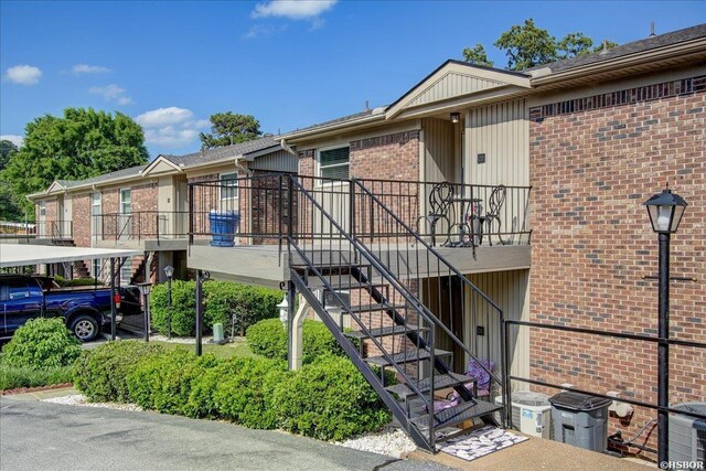 view of property featuring stairway and a carport