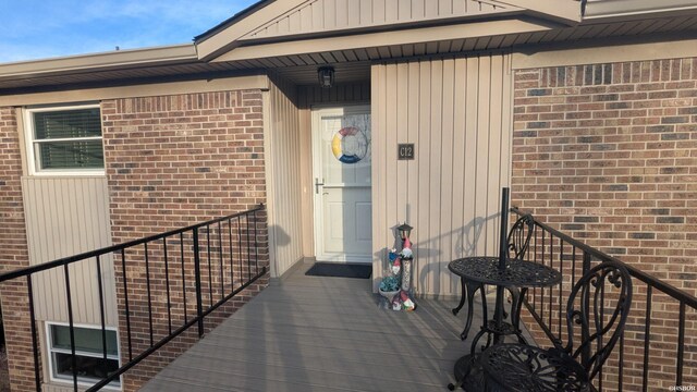 view of exterior entry with brick siding