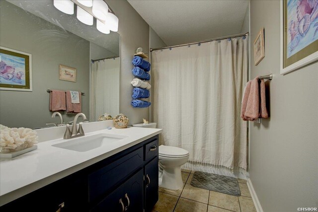 full bathroom with tile patterned flooring, vanity, toilet, and a textured ceiling