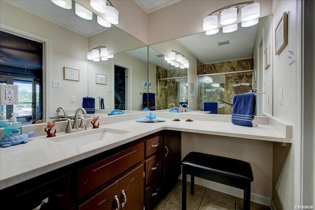 bathroom with tile patterned flooring, crown molding, a shower stall, and vanity