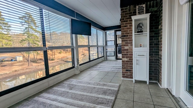 sunroom / solarium featuring vaulted ceiling