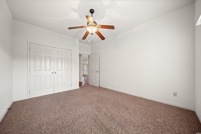 unfurnished bedroom featuring ceiling fan, a closet, baseboards, and carpet flooring