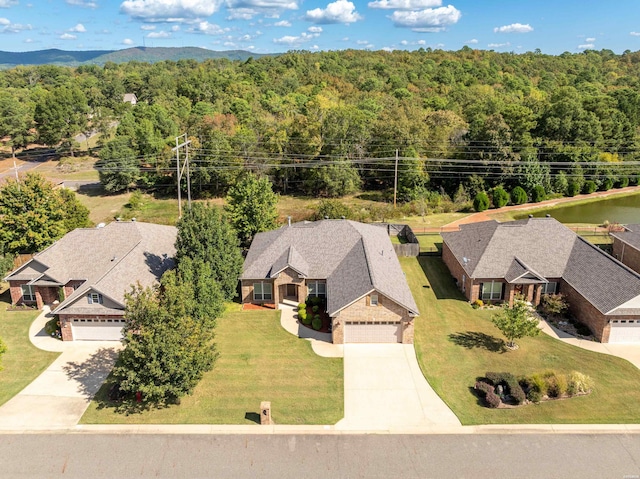 birds eye view of property featuring a wooded view