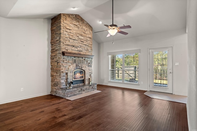 unfurnished living room featuring baseboards, a ceiling fan, dark wood-style floors, vaulted ceiling, and a fireplace