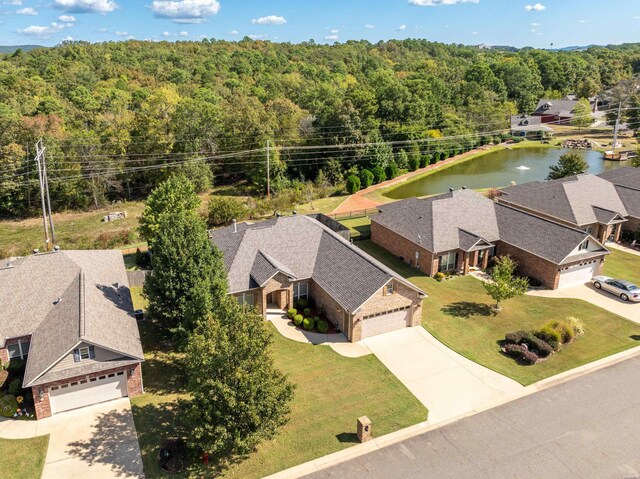 drone / aerial view with a residential view and a view of trees