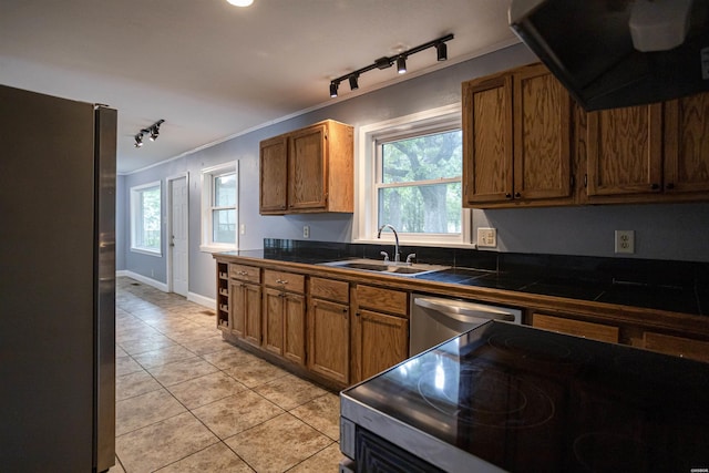 301 Riley St, Hot Springs, AR 71901 - kitchen featuring a sink, appliances with stainless steel finishes, light tile patterned flooring, rail lighting, and range hood