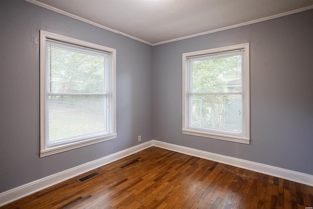301 Riley St, Hot Springs, AR 71901 - empty room with visible vents, crown molding, dark wood-style floors, and baseboards