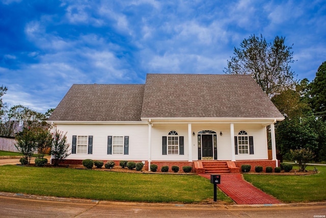 view of front of house with a front yard and roof with shingles