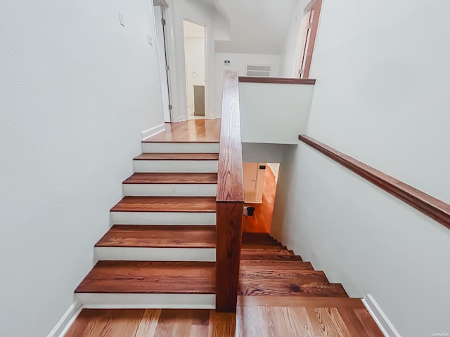 stairway with visible vents and baseboards