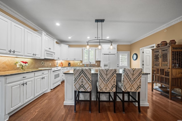 1380 Airport Rd Unit E-1, Hot Springs, AR 71913 - kitchen with white appliances, crown molding, a kitchen bar, dark wood-style flooring, and white cabinetry