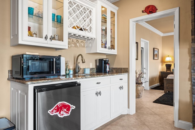 1380 Airport Rd Unit E-1, Hot Springs, AR 71913 - kitchen featuring fridge, crown molding, dark stone counters, glass insert cabinets, and white cabinets