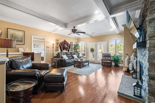 1380 Airport Rd Unit E-1, Hot Springs, AR 71913 - living room featuring a stone fireplace, coffered ceiling, ceiling fan, wood-type flooring, and crown molding