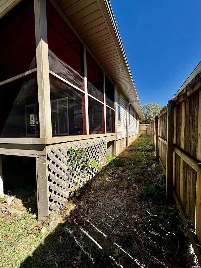 view of side of home featuring a fenced backyard