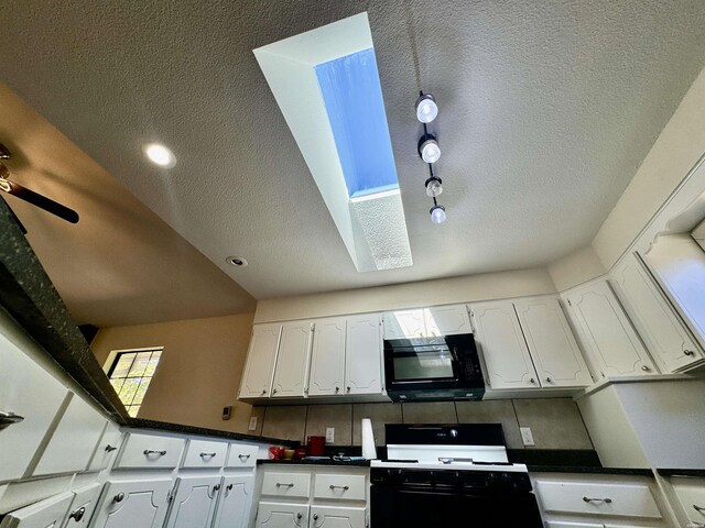 kitchen featuring dark countertops, decorative backsplash, white cabinetry, a textured ceiling, and black appliances