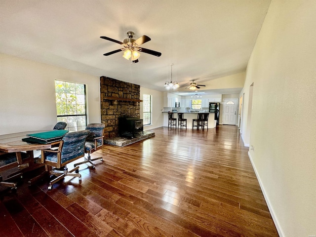 interior space with lofted ceiling, dark wood-style floors, ceiling fan, and baseboards