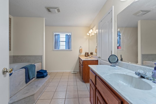103 Deer View Ct, Hot Springs, AR 71913 - bathroom featuring two vanities, a garden tub, tile patterned floors, a textured ceiling, and baseboards
