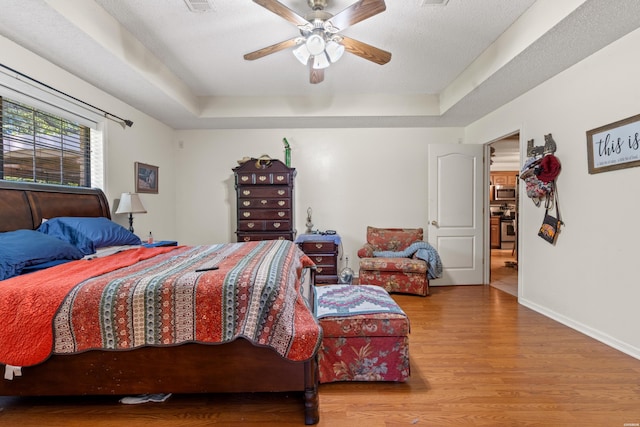103 Deer View Ct, Hot Springs, AR 71913 - bedroom featuring a raised ceiling, wood finished floors, baseboards, and a ceiling fan