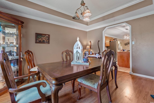 103 Deer View Ct, Hot Springs, AR 71913 - dining space with light wood-style flooring, a chandelier, ornamental molding, arched walkways, and baseboards