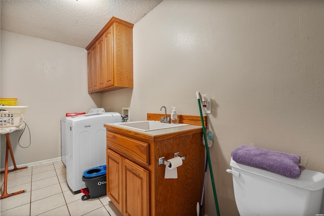 103 Deer View Ct, Hot Springs, AR 71913 - laundry area with washing machine and dryer, cabinet space, light tile patterned flooring, a textured ceiling, and baseboards