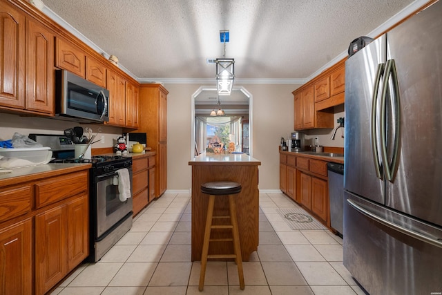 103 Deer View Ct, Hot Springs, AR 71913 - kitchen featuring appliances with stainless steel finishes, a kitchen island, brown cabinets, crown molding, and light tile patterned floors