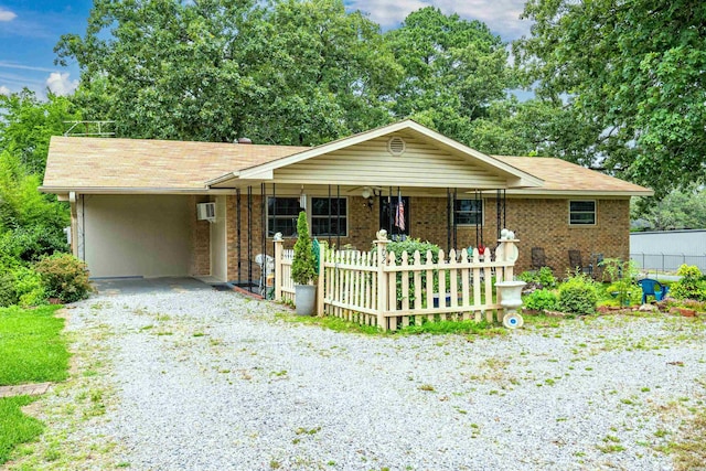 102 Avalon Dr, Pearcy, AR 71964 - ranch-style home featuring gravel driveway, an attached carport, roof with shingles, and covered porch