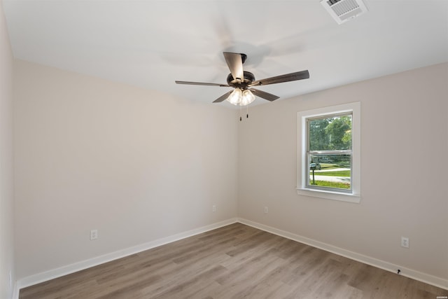 unfurnished room featuring light wood-type flooring, visible vents, and baseboards