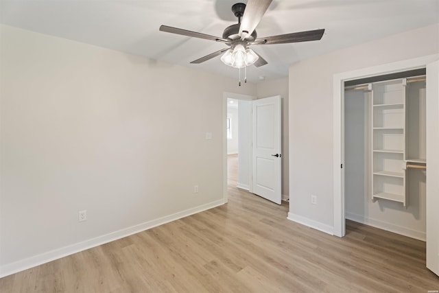 unfurnished bedroom featuring baseboards, ceiling fan, a closet, and light wood-style floors