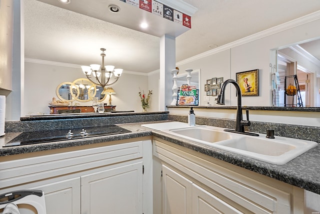 kitchen featuring a notable chandelier, black electric stovetop, dark countertops, ornamental molding, and a sink