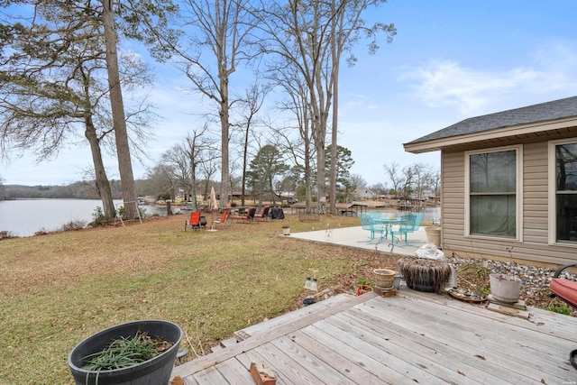 view of yard with a patio area and a deck with water view