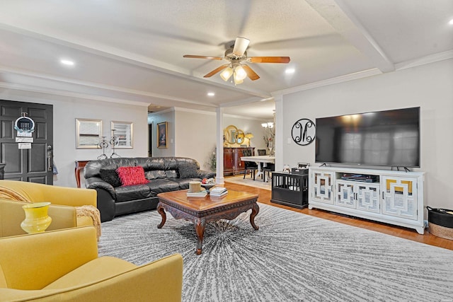 living area featuring beam ceiling, crown molding, recessed lighting, a ceiling fan, and wood finished floors