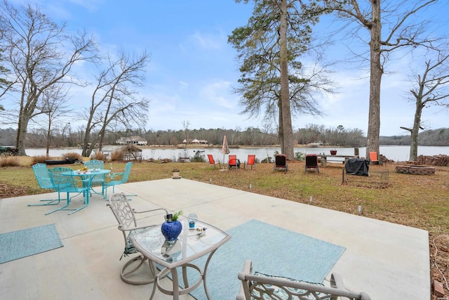 view of patio featuring a water view and outdoor dining space