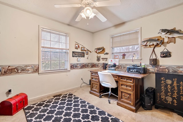 office space featuring ornamental molding, light colored carpet, a textured ceiling, and a ceiling fan