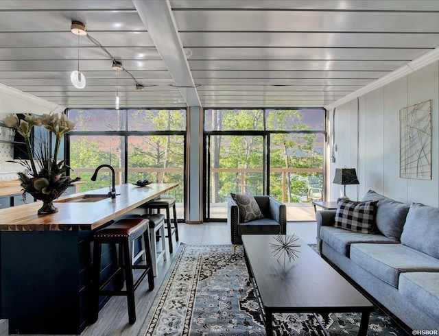 sunroom / solarium with a sink