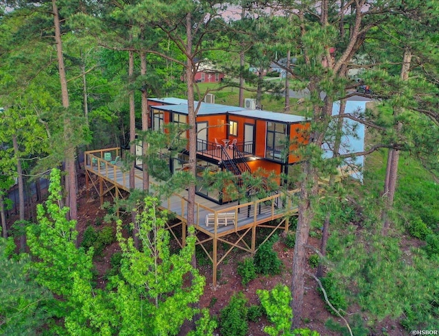 rear view of property featuring a wooden deck