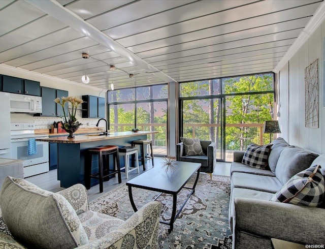 sunroom / solarium with wooden ceiling and a sink