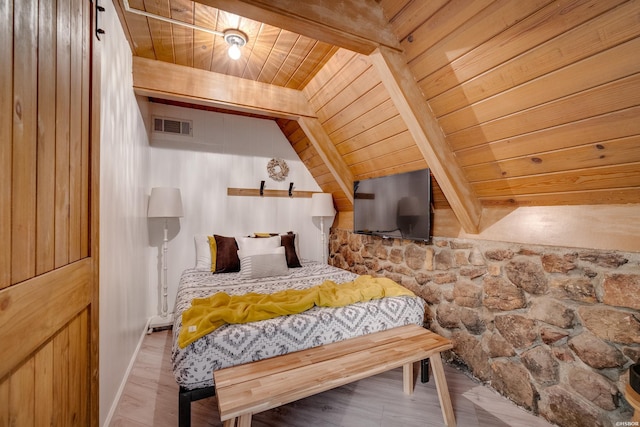 bedroom featuring lofted ceiling with beams, wood ceiling, and visible vents