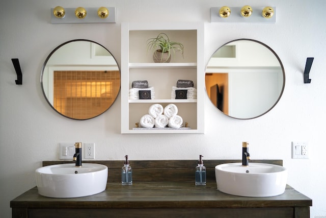 bathroom featuring built in shelves and a sink