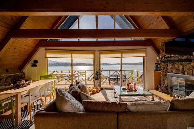 living area featuring wood ceiling, vaulted ceiling with beams, and a stone fireplace