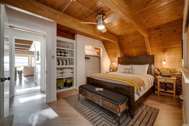 bedroom with wood ceiling, light wood finished floors, a closet, and beam ceiling