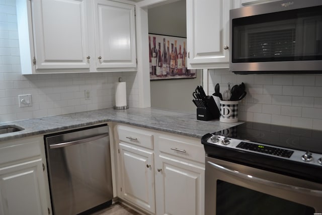 200 Hamilton Oaks Dr Unit J3, Hot Springs, AR 71913 - kitchen with appliances with stainless steel finishes, tasteful backsplash, white cabinetry, and light stone counters