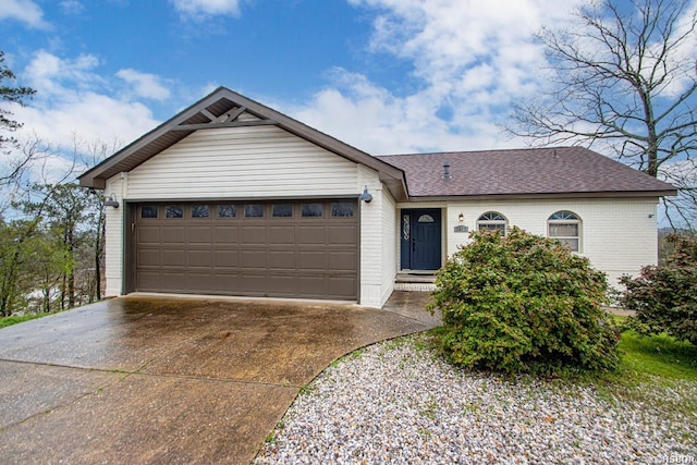 ranch-style house featuring a garage, brick siding, driveway, and roof with shingles