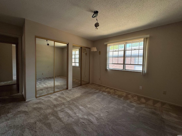 600 Higdon Ferry Rd Unit 203, Hot Springs, AR 71901 - unfurnished bedroom with multiple windows, multiple closets, carpet floors, and a textured ceiling