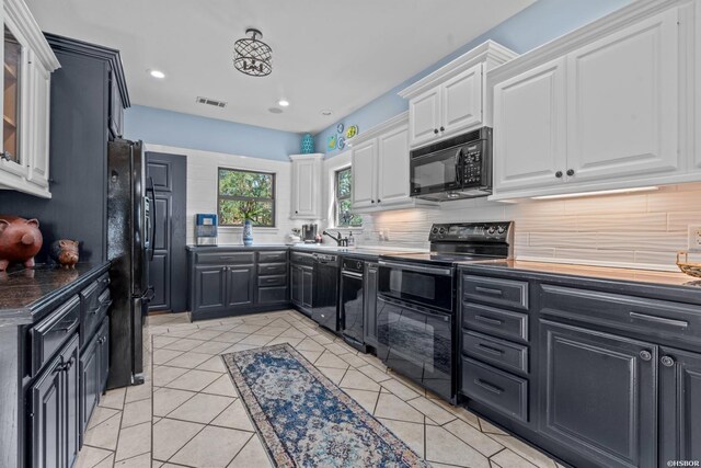 kitchen featuring black appliances, white cabinets, and dark cabinetry