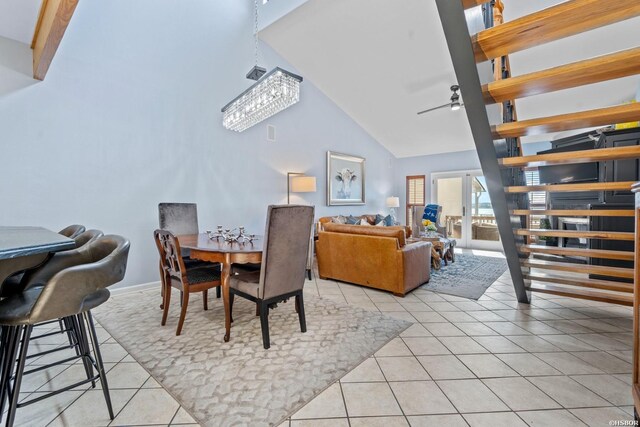 dining room with high vaulted ceiling, ceiling fan, baseboards, and light tile patterned floors