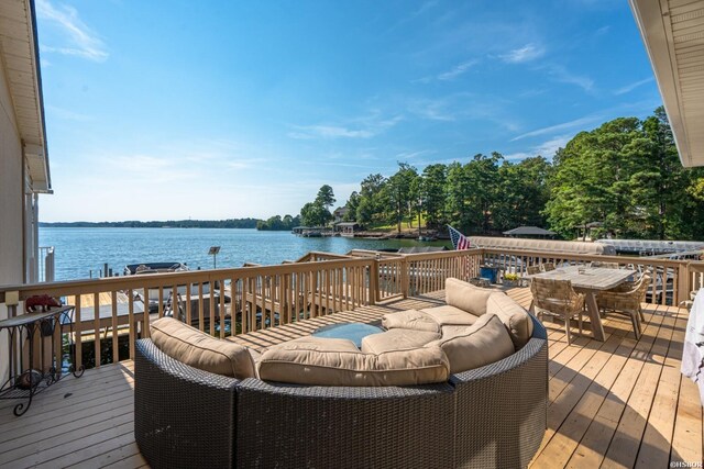 deck with a water view, an outdoor hangout area, and outdoor dining area