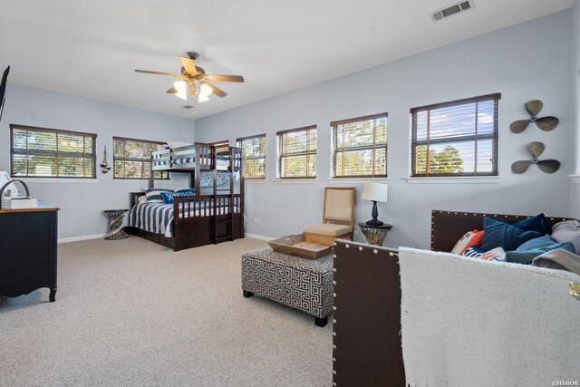 carpeted bedroom featuring visible vents and baseboards